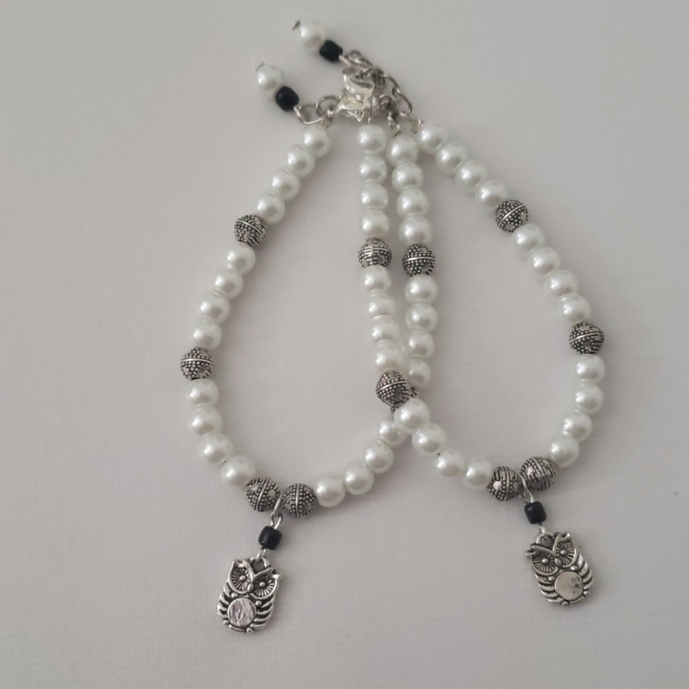 Two pearl and silver bracelets with owl charm